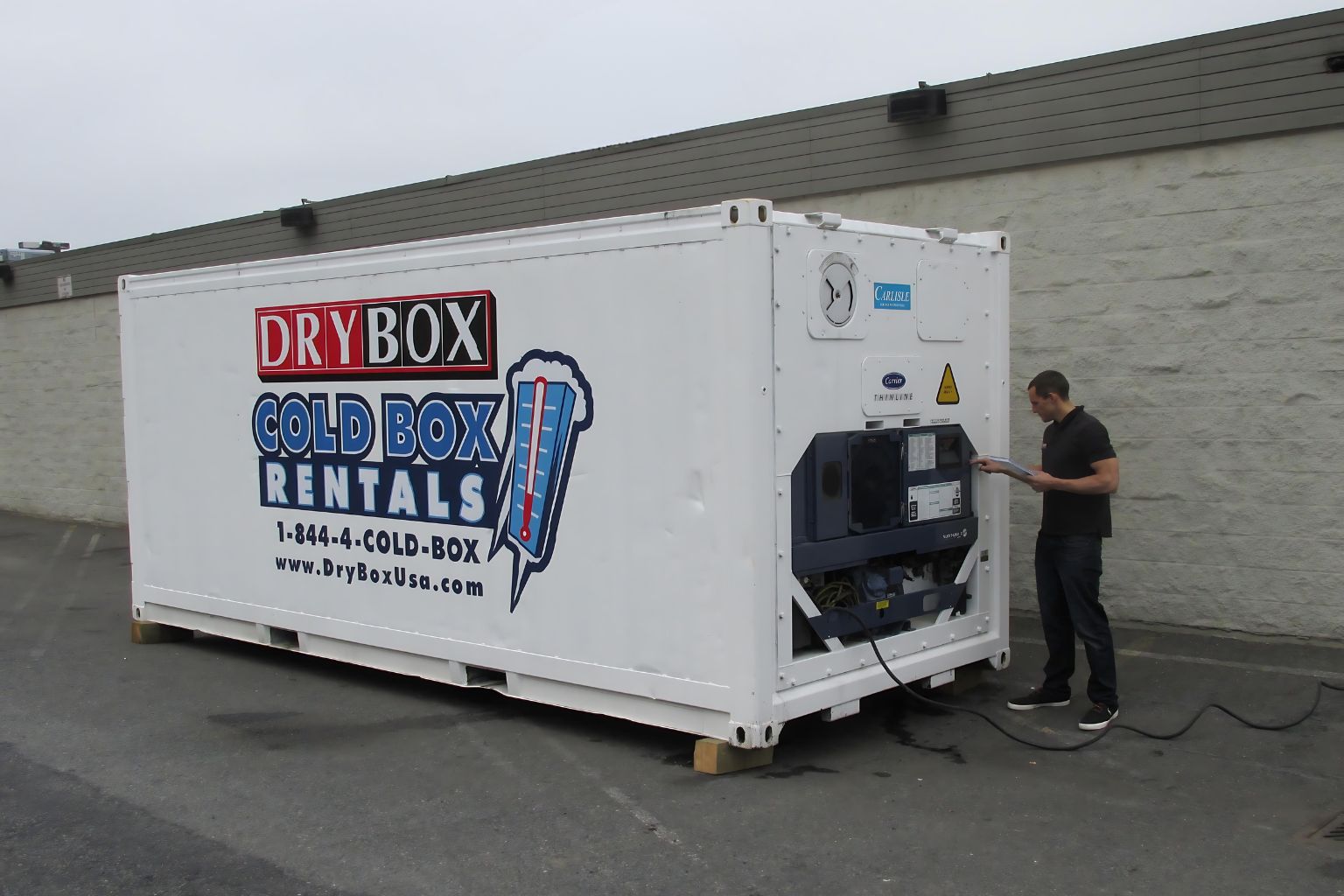 Man performing maintenance on a cold storage container